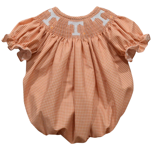 A baby bubble romper in a peach and white gingham check pattern, featuring a smocked neckline with white embroidered letters spelling 'Tennessee'.
