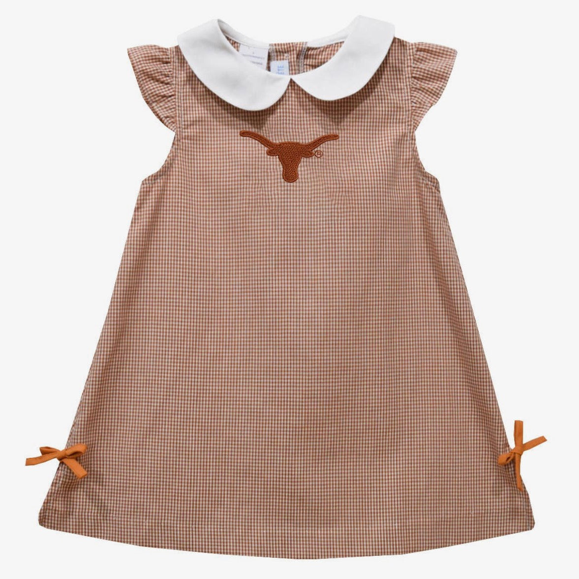 A toddler girl's sleeveless dress featuring a brown and beige gingham pattern, a white Peter Pan collar, a brown embroidered Longhorn logo on the chest, and matching brown ribbon bows on the sides.