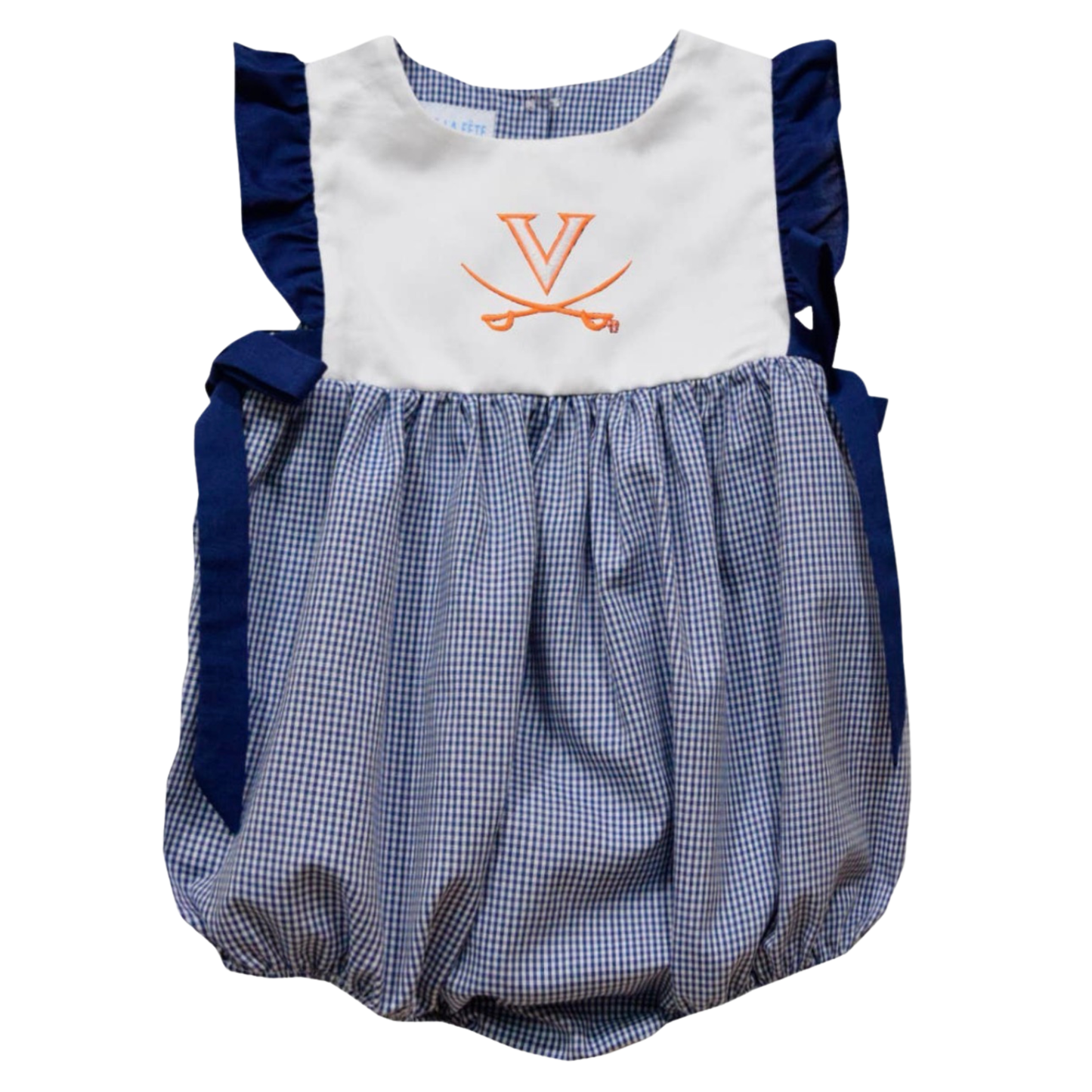 A baby girl's two-piece outfit set featuring a long-sleeve ruffle dress and matching bloomers. The dress is light blue and white gingham with orange pumpkin prints and the name 'Kennedy' embroidered in orange across the chest.