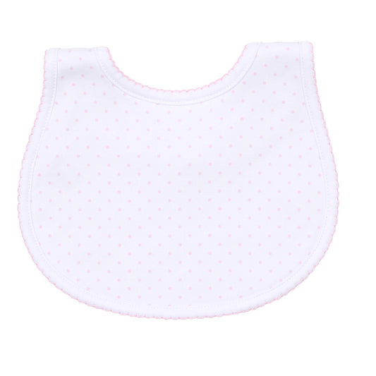 White baby bib with pink polka dots on a white background