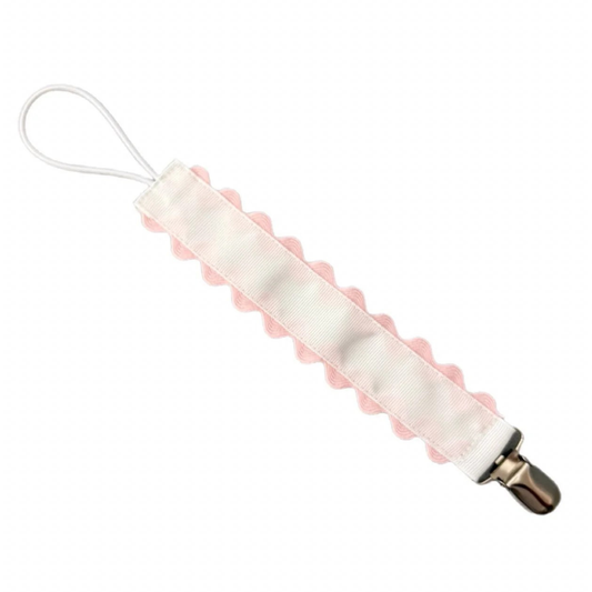 White pacifier clip with pink silicone bumper on a white background