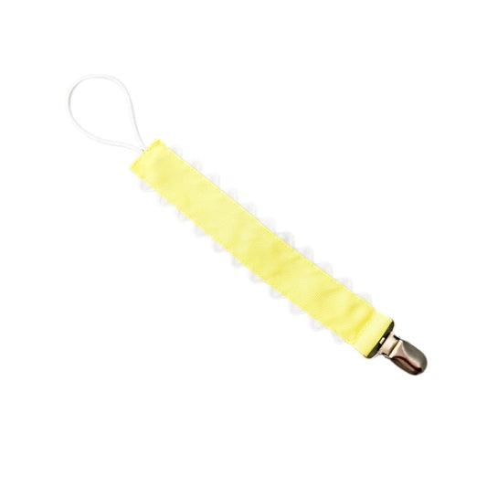 Yellow pacifier clip on a white background